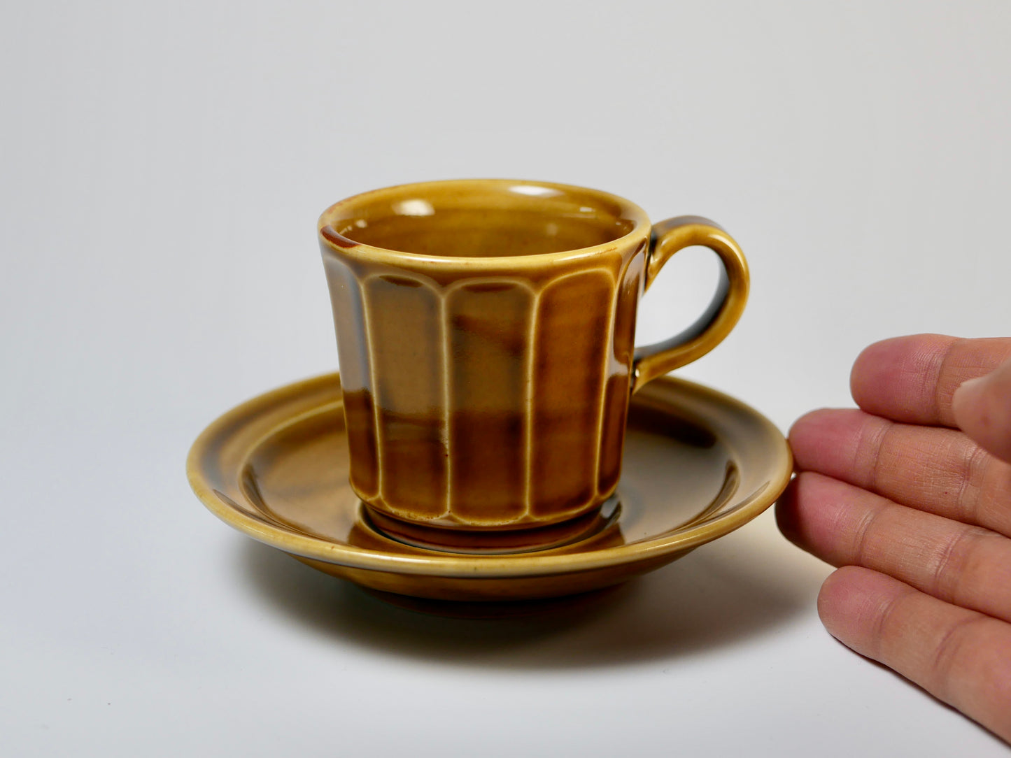 Chamfered yellow porcelain cup and saucer