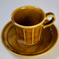 Chamfered yellow porcelain cup and saucer