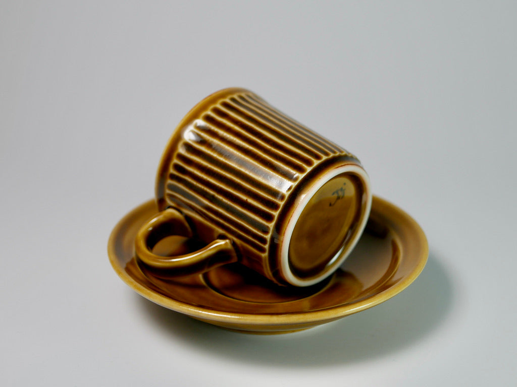 Ribbed yellow porcelain cup and saucer